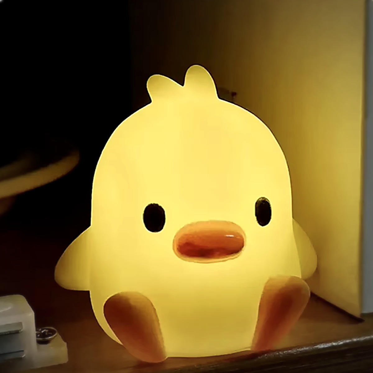 Duck Glow Buddy glowing on a bedroom shelf