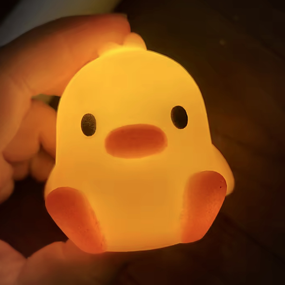 Duck Glow Buddy glowing in the palm of a hand