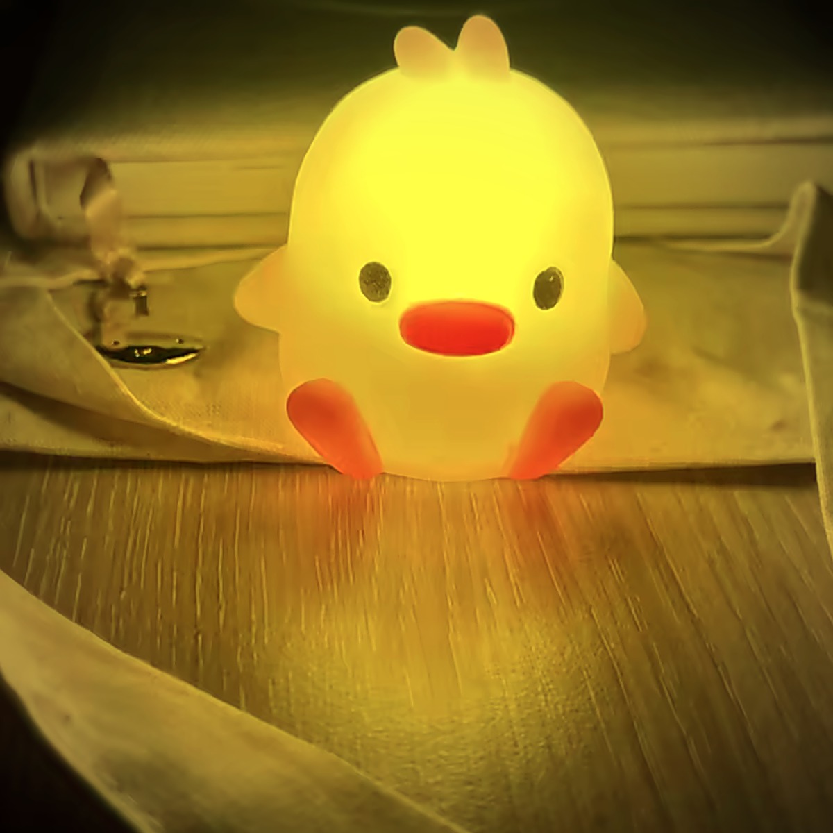 Duck Glow Buddy glowing on a nightstand